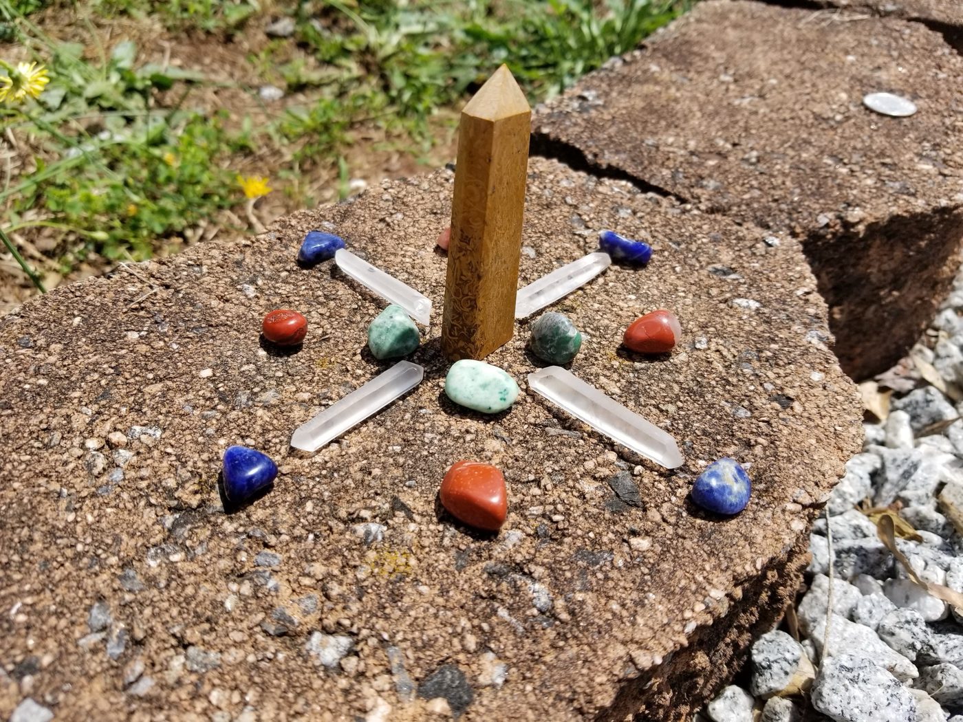 A real crystal grid built with a tiger's eye point and tumbled stones for spell work